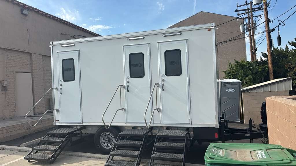 3 station restroom trailer in the parking lot (restroom trailer rental, Oregon)