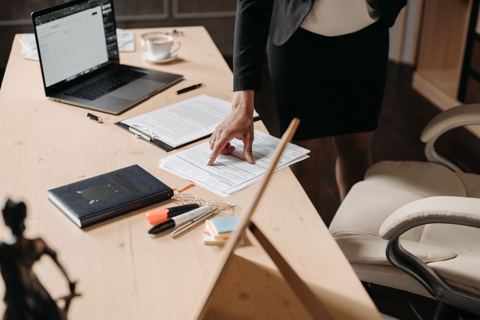 A laptop and paperwork on an office desk