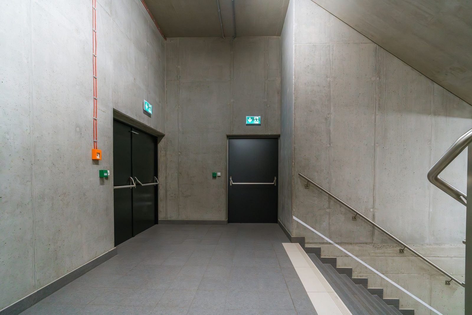 A plain building corridor with exit doors