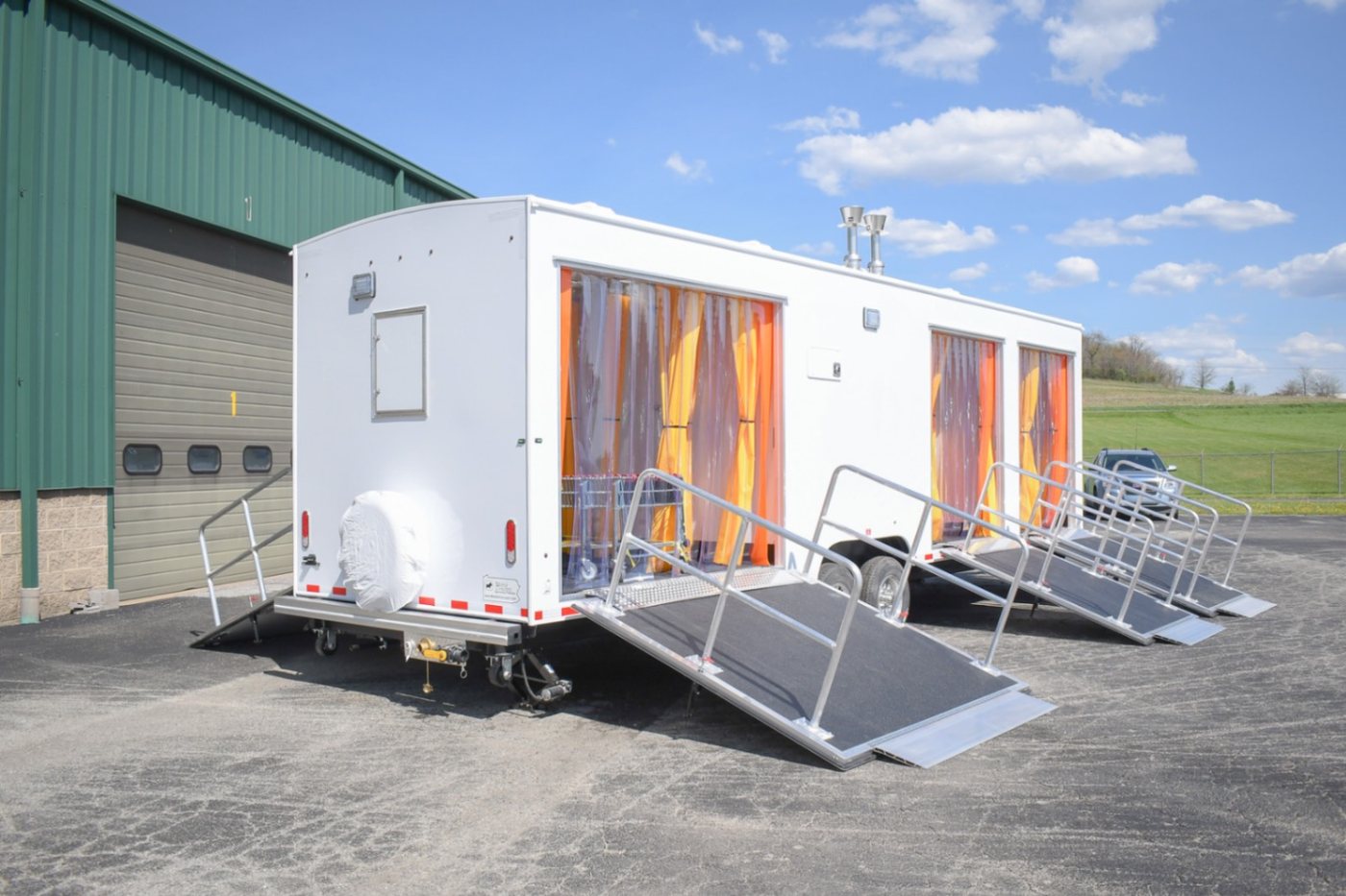 Decontamination unit set at a work site with its staged entry doors along the service side