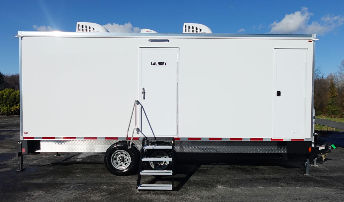White laundry trailer rental with utility door open and fold down entry steps deployed