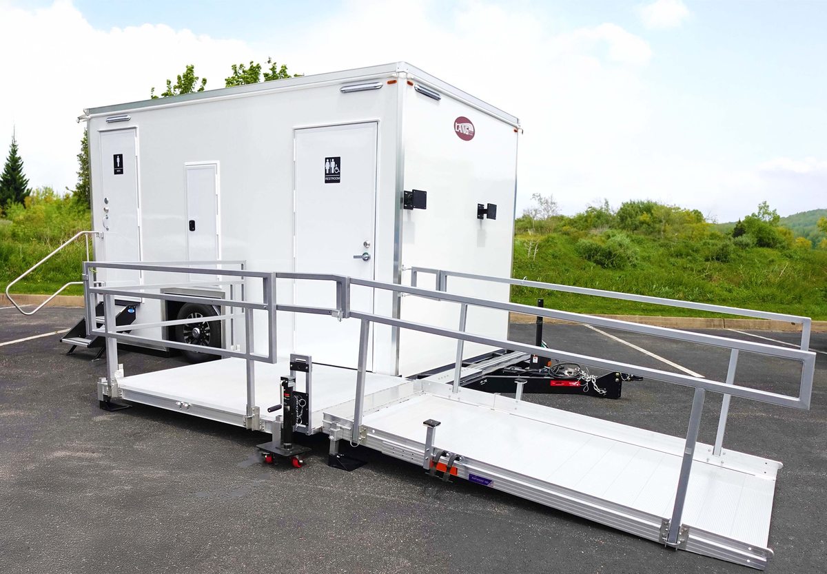 ADA plus two restroom trailer with wheelchair ramp deployed on the entry side