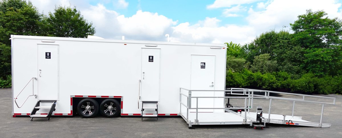 Six station accessible bathroom trailer rental with ramp system and standard doors down the side