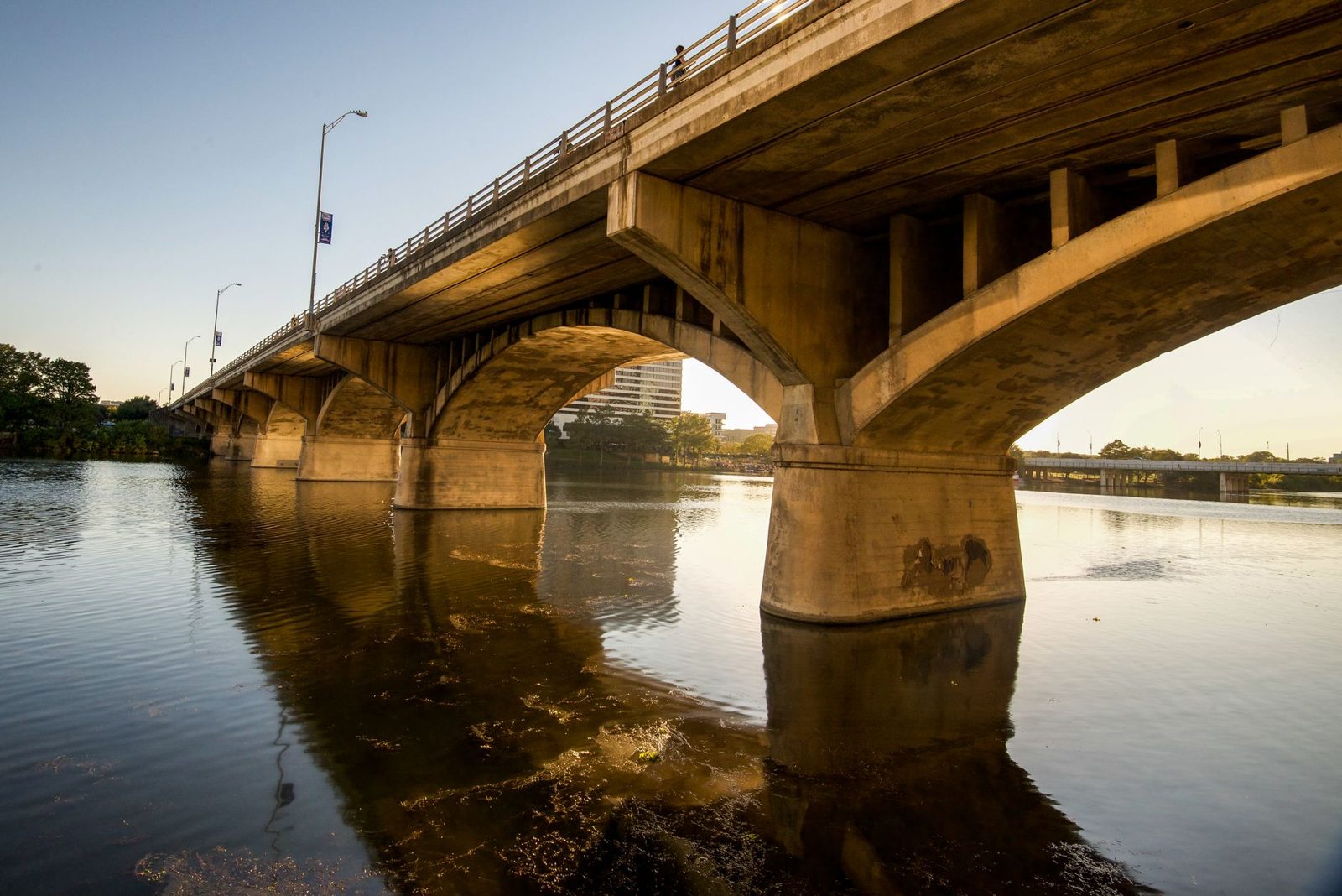 A highway bridge over a Texas river at dusk