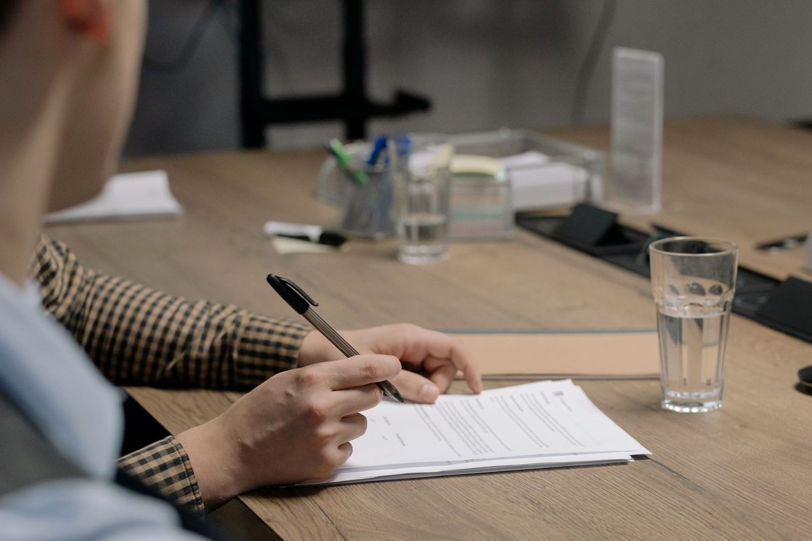 A person reviewing contract papers at a desk