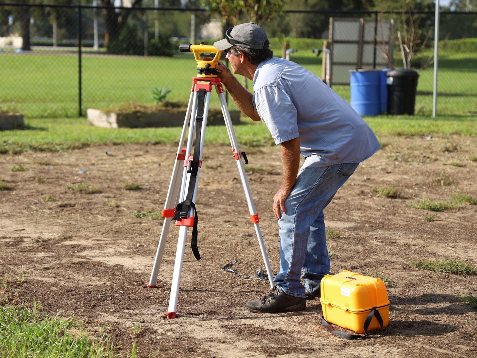 A field crew member working with survey equipment outdoors