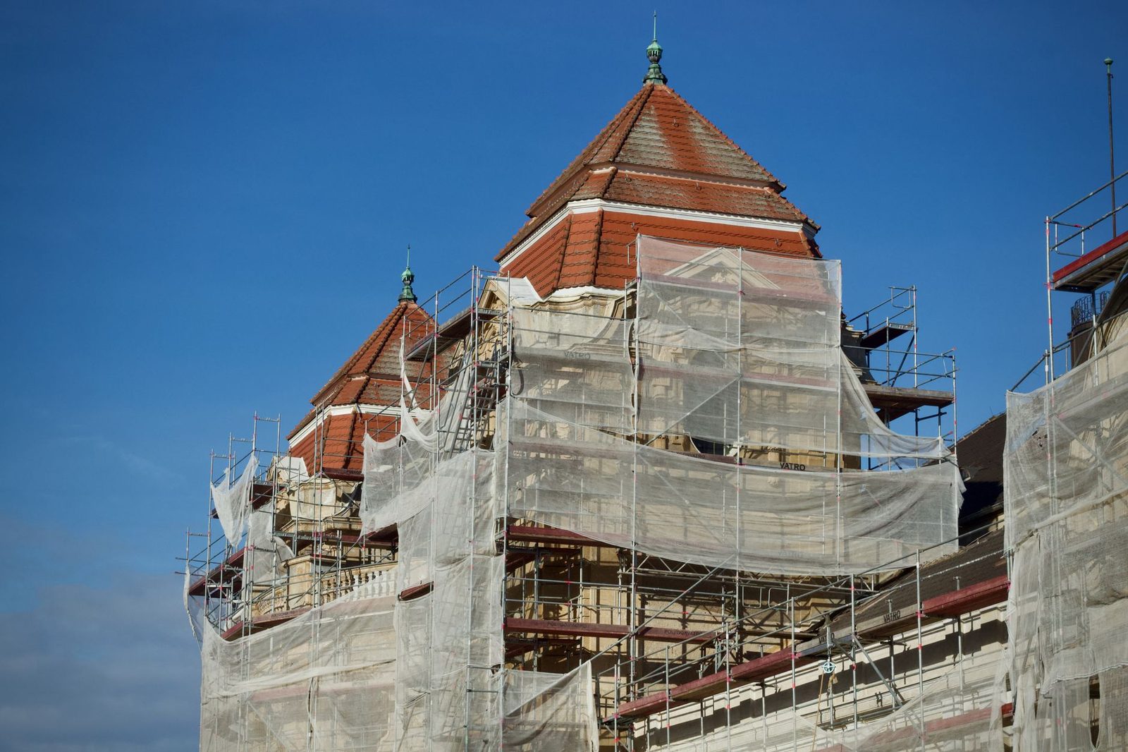 A historic building wrapped in scaffolding during a renovation