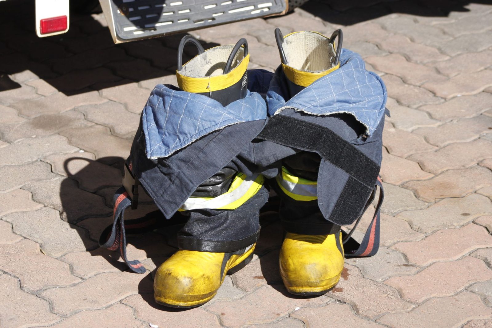 Firefighter boots and turnout pants set out to dry
