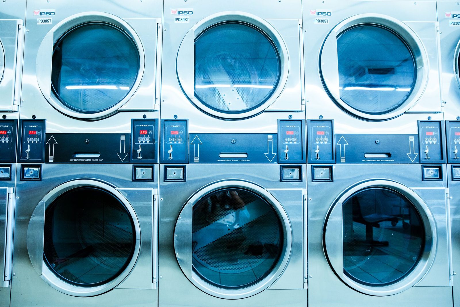 A wall of front-load commercial washing machines