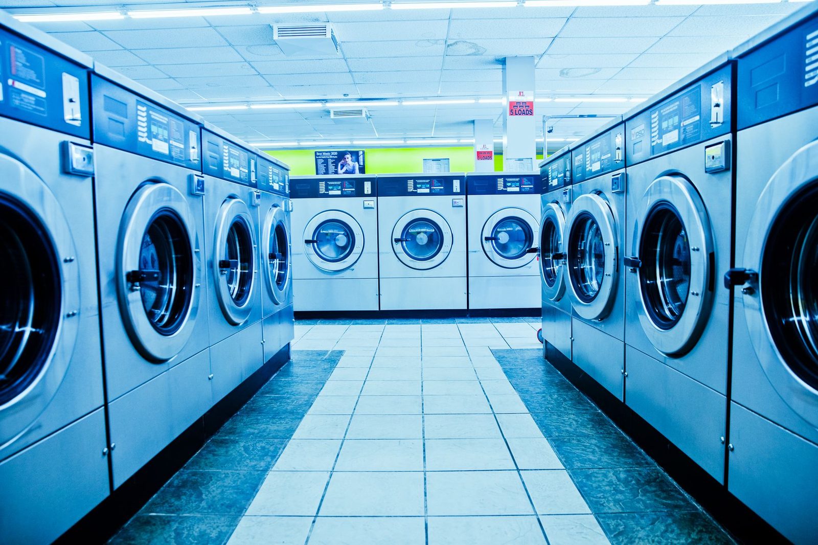 A long aisle of front-load washers