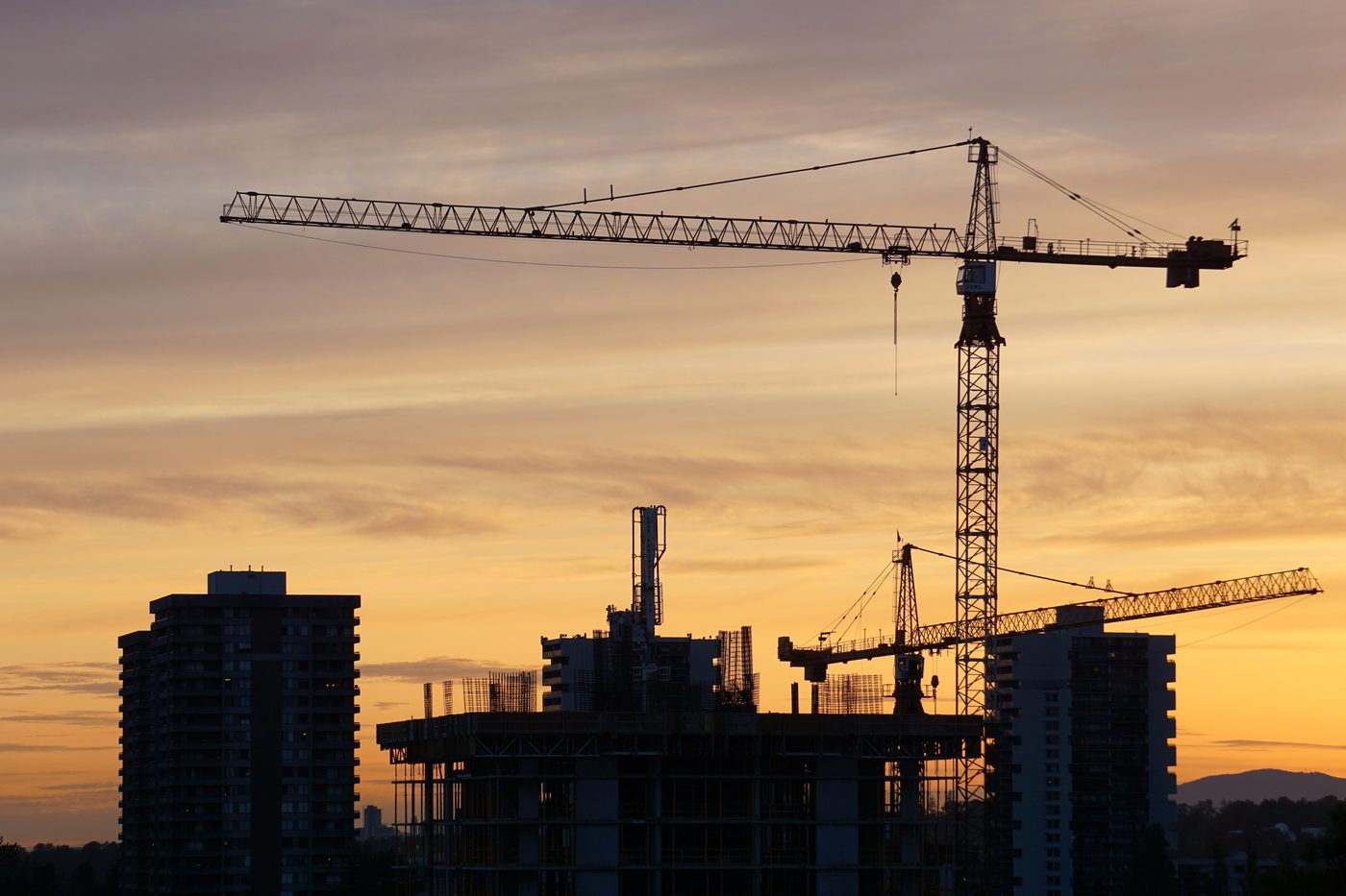 Tower cranes over a large multi year construction program at dusk