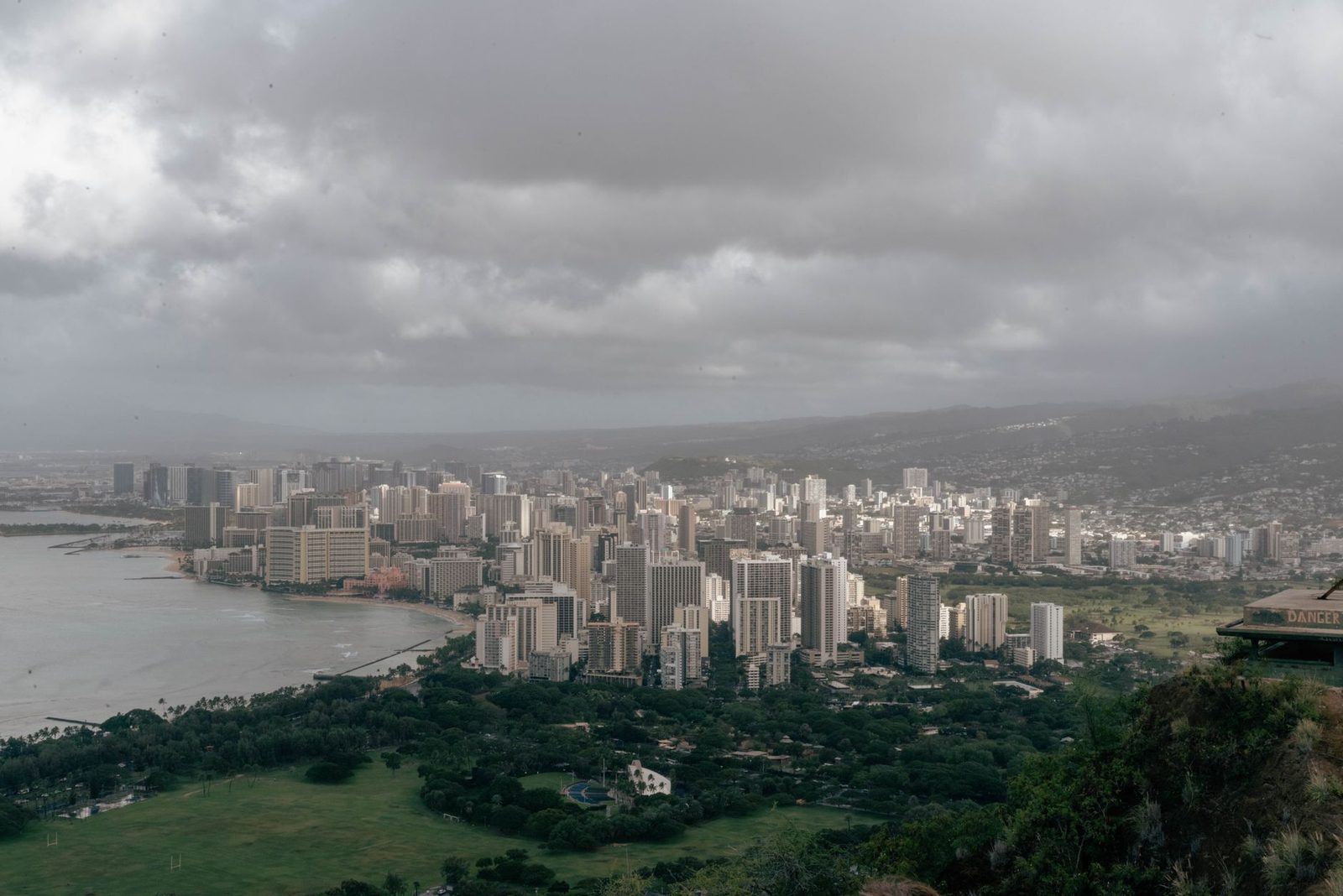 Honolulu under a gray overcast sky, seen from the hills above the city