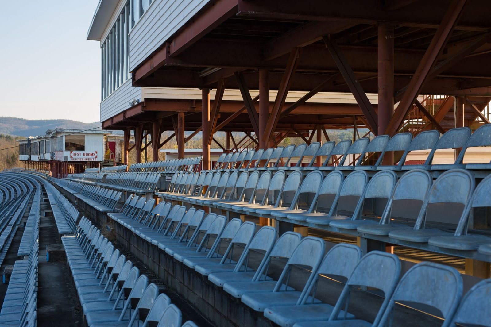 Empty covered grandstand seating at a fairground arena